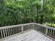 Wooden deck overlooking a lush, green backyard with mature trees at 675 Stonebridge Loop, Lithonia, GA 30058