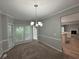 Neutral dining area with modern lighting and carpet at 675 Stonebridge Loop, Lithonia, GA 30058