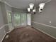 Cozy dining area with modern chandelier and carpet at 675 Stonebridge Loop, Lithonia, GA 30058