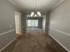 Bright dining room with modern chandelier and open doorway at 675 Stonebridge Loop, Lithonia, GA 30058