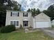 Charming two-story home with attached garage and neutral siding at 675 Stonebridge Loop, Lithonia, GA 30058