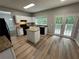 Well-lit kitchen with granite countertops, island, and patio access at 675 Stonebridge Loop, Lithonia, GA 30058