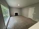 Living room with fireplace, large window, and plush carpeting at 675 Stonebridge Loop, Lithonia, GA 30058