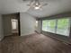 Main bedroom with carpet, ceiling fan, and ensuite bathroom access at 675 Stonebridge Loop, Lithonia, GA 30058