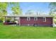 Home exterior features a green yard, a covered porch, and a well maintained lawn at 823 Catherine St, Forest Park, GA 30297