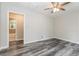 Neutral bedroom featuring grey wood-look flooring, a ceiling fan, and access to an ensuite bathroom at 823 Catherine St, Forest Park, GA 30297