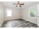 Bedroom features a ceiling fan, a window, and gray wood-look flooring at 823 Catherine St, Forest Park, GA 30297