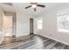 Bright bedroom features a ceiling fan, a window, and gray wood-look flooring at 823 Catherine St, Forest Park, GA 30297