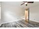 Bright bedroom features a ceiling fan, a window, and gray wood-look flooring at 823 Catherine St, Forest Park, GA 30297