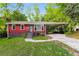 Cozy, red brick single story home featuring a large covered carport and landscaped front yard at 823 Catherine St, Forest Park, GA 30297
