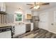 Well-lit kitchen with stainless steel appliances, white cabinets, and stylish geometric tiled backsplash at 823 Catherine St, Forest Park, GA 30297