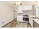 The kitchen features white cabinets, stainless steel appliances, and stylish geometric tiled backsplash at 823 Catherine St, Forest Park, GA 30297