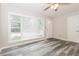Inviting living room with a large window offering plenty of natural light and gray wood-look flooring at 823 Catherine St, Forest Park, GA 30297