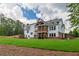 Expansive backyard featuring well-maintained lawn, covered porch, and multi-story home at 100 Ashley Hall Ct, Woodstock, GA 30188