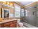 Well-lit bathroom features a granite vanity, walk-in shower, and neutral tones, creating a refreshing and practical space at 100 Ashley Hall Ct, Woodstock, GA 30188