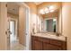 Bathroom with a granite countertop vanity, sink, and a large mirror with lighting at 100 Ashley Hall Ct, Woodstock, GA 30188