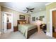 Cozy bedroom with a comfortable bed, a sitting area, and a glimpse of an en-suite bathroom, offering a private retreat at 100 Ashley Hall Ct, Woodstock, GA 30188
