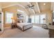 Spacious bedroom featuring vaulted ceiling, neutral carpet, and a wall of windows with picturesque views, creating a peaceful retreat at 100 Ashley Hall Ct, Woodstock, GA 30188