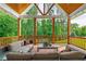 Comfortable covered deck with wooden columns and railings overlooks private, wooded backyard at 100 Ashley Hall Ct, Woodstock, GA 30188