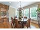 Bright dining area with large windows, hardwood floors, and stylish light fixture at 100 Ashley Hall Ct, Woodstock, GA 30188