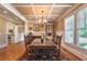 Bright dining area featuring hardwood floors, large windows, and built-in cabinets, perfect for entertaining at 100 Ashley Hall Ct, Woodstock, GA 30188