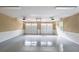 Clean and spacious two-car garage featuring an epoxy floor, bright lighting, and two garage doors at 100 Ashley Hall Ct, Woodstock, GA 30188