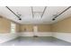 Spacious two-car garage with epoxy flooring, bright lighting, and ample storage space at 100 Ashley Hall Ct, Woodstock, GA 30188