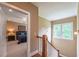 Hallway view overlooking a carpeted bedroom with a ceiling fan at 100 Ashley Hall Ct, Woodstock, GA 30188