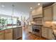 Spacious kitchen with stainless steel appliances, granite counters, and a hardwood floor at 100 Ashley Hall Ct, Woodstock, GA 30188