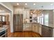 Open concept kitchen with stainless appliances, granite counters, and hardwood floors at 100 Ashley Hall Ct, Woodstock, GA 30188