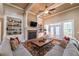 Cozy living room with a brick fireplace, built-in bookshelves, and French doors leading to the deck at 100 Ashley Hall Ct, Woodstock, GA 30188