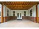 Covered brick patio featuring exposed beam ceiling and double doors, perfect for outdoor entertaining at 100 Ashley Hall Ct, Woodstock, GA 30188