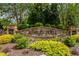 Stone sign for Ashley Hall community, surrounded by lush greenery and mature trees at 100 Ashley Hall Ct, Woodstock, GA 30188
