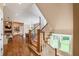 Inviting staircase with wooden stairs and white railings leading to the home's upper level, complemented by natural light and hardwood floors at 100 Ashley Hall Ct, Woodstock, GA 30188