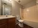 Bathroom with wood vanity, tub/shower, and toilet, offering functionality and style at 1048 Brandon Ln, Stone Mountain, GA 30083