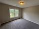 Comfortable bedroom with a large window and neutral carpeting, ready for personalization at 1048 Brandon Ln, Stone Mountain, GA 30083