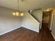 Dining area showcasing wood floors, staircase, and adjacent hallway at 1048 Brandon Ln, Stone Mountain, GA 30083