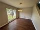 Bright dining area featuring wood floors, large window, and classic chandelier at 1048 Brandon Ln, Stone Mountain, GA 30083