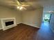 Bright living room with a fireplace and ceiling fan, enhanced by wood floors and natural light at 1048 Brandon Ln, Stone Mountain, GA 30083