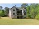 Large backyard features a well-maintained lawn and a stylish home exterior at 10765 Shallowford Rd, Roswell, GA 30075