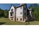Large, modern home with brick and stone exterior and well-manicured lawn at 10765 Shallowford Rd, Roswell, GA 30075