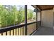 Spacious balcony overlooking a lush green backyard with trees and tiered landscaping at 10765 Shallowford Rd, Roswell, GA 30075