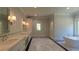 Elegant bathroom featuring double vanities, marble countertops, and a modern standalone soaking tub at 10765 Shallowford Rd, Roswell, GA 30075
