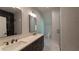 Bathroom with double vanity, granite countertops, marble floors, two mirrors, and a glass-enclosed walk-in shower at 10765 Shallowford Rd, Roswell, GA 30075
