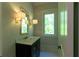 Stylish powder room features a marble countertop, decorative lighting, and modern fixtures at 10765 Shallowford Rd, Roswell, GA 30075