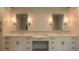 Bathroom featuring double sinks, vanity with marble countertops, and elegant lighting fixtures at 10765 Shallowford Rd, Roswell, GA 30075