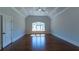 Bright, airy bedroom with hardwood floors and coffered ceilings and a large window at 10765 Shallowford Rd, Roswell, GA 30075