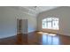 Bright, airy bedroom with hardwood floors and coffered ceilings and a large window at 10765 Shallowford Rd, Roswell, GA 30075