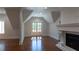 Bright bonus room featuring hardwood floors, fireplace and double doors to the outside at 10765 Shallowford Rd, Roswell, GA 30075