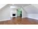 Bonus room with hardwood floors, a fireplace, and plenty of open space for various activities at 10765 Shallowford Rd, Roswell, GA 30075